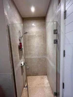 a shower with a glass door in a bathroom at Cozy 1-bedroom Joubal lagoon apartment in Hurghada