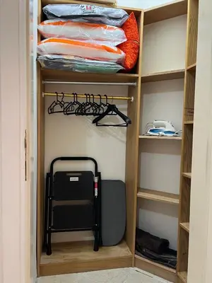 a walk in closet with a shelf with a suitcase at green garden resort in Hurghada