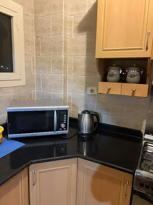 a kitchen with a microwave on a counter at green garden resort in Hurghada
