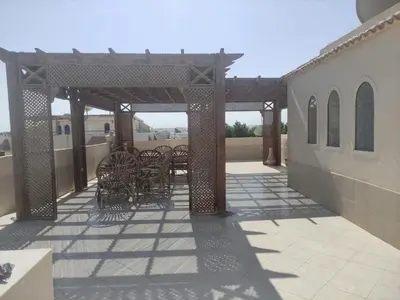 a patio with chairs and tables on top of a building at green garden resort in Hurghada
