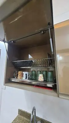 a kitchen shelf with pots and pans on it at La Luna Garden Magawish in Hurghada