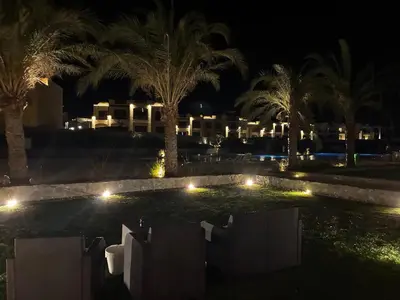 a resort at night with palm trees and lights at 1BR Chalet at Makadi Heights Hurghada in Hurghada
