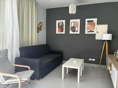 a living room with a blue couch and a table at 1BR Chalet at Makadi Heights Hurghada in Hurghada