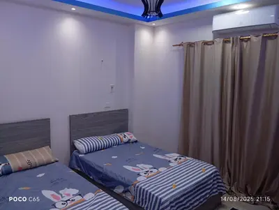 a bedroom with two beds with hello kitty pillows at Red Ruby chalets &flats HRG,Elgouna in Hurghada