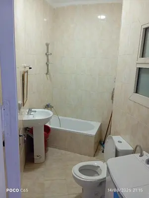 a bathroom with a tub and a toilet and a sink at Red Ruby chalets &flats HRG,Elgouna in Hurghada