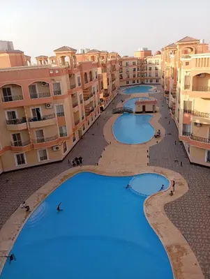 an overhead view of three large pools in a building at Red Ruby chalets &flats HRG,Elgouna in Hurghada