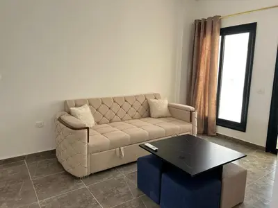 a living room with a couch and a coffee table at Aqua infinity resort in Hurghada