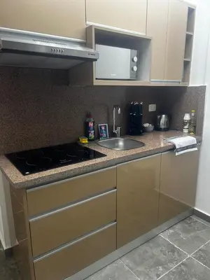 a kitchen counter with a sink and a stove at Aqua infinity resort in Hurghada