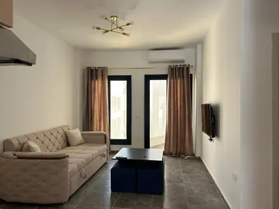 a living room with a couch and a table at Aqua infinity resort in Hurghada