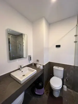 a bathroom with a white toilet and a sink at Bali chalet with private heated pool in Hurghada