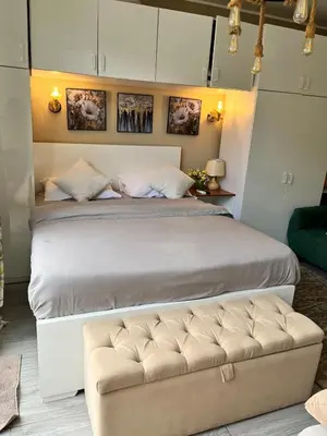 a bedroom with a large bed and a couch at Elegant Studio in El Gouna in Hurghada