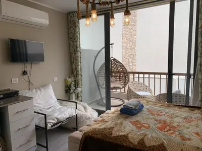 a bedroom with a bed and a balcony at Elegant Studio in El Gouna in Hurghada