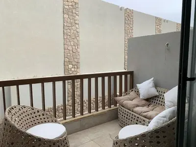 a balcony with two chairs and a couch at Elegant Studio in El Gouna in Hurghada