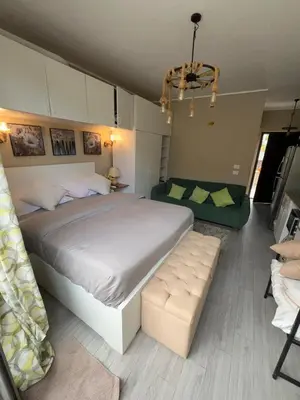 a bedroom with a large bed and a couch at Elegant Studio in El Gouna in Hurghada