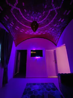 a purple room with a ceiling with purple lights at Queen of Merit in Luxor