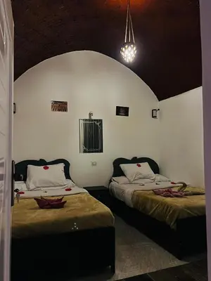 a room with two beds in a room at Queen of Merit in Luxor