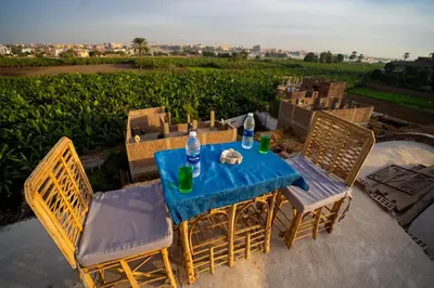 a blue table with chairs and water bottles on it at Queen of Merit in Luxor