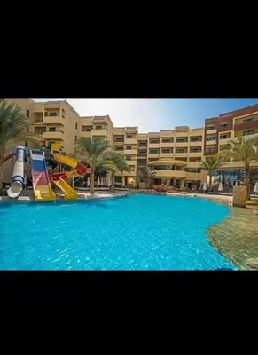 a large swimming pool with a slide in front of a building at قريه الدهبيه in Hurghada