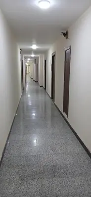 an empty hallway with white walls and floors and doors at Hurghada Tiba Golden Beach Resort Down Town in Hurghada