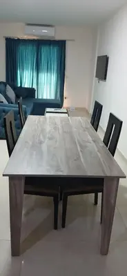 a large wooden table with chairs in a living room at Hurghada Tiba Golden Beach Resort Down Town in Hurghada