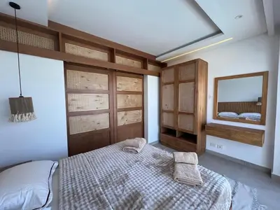 a bedroom with a large bed and a mirror at Maraya El Gouna in Hurghada