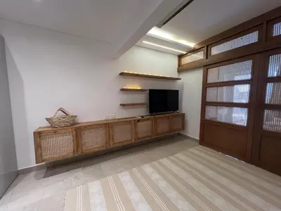 a living room with a flat screen tv and a door at Maraya El Gouna in Hurghada