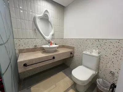 a bathroom with a white toilet and a sink at Maraya El Gouna in Hurghada
