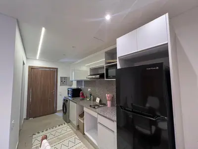 a kitchen with a black refrigerator in a room at Maraya El Gouna in Hurghada