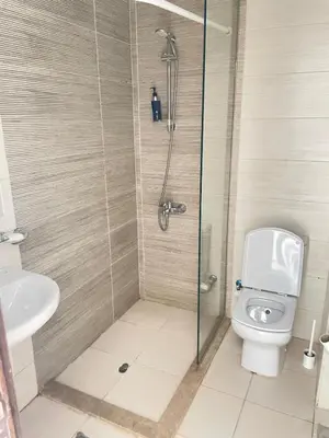 a bathroom with a shower and a toilet at Two-bedroom apartment in G Cribs in Hurghada