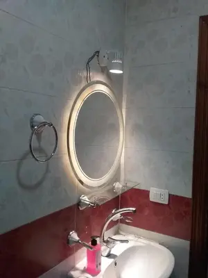 a bathroom with a sink and a mirror at Rich Home Hurghada in Hurghada
