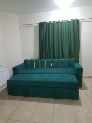 a blue couch in a room with a green curtain at Rich Home Hurghada in Hurghada