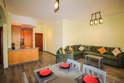a living room with a couch and a table and chairs at All View Apartements, Sahl Hasheesh, El Andalous in Hurghada