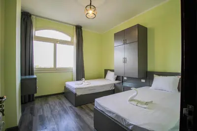 a small room with two beds and a window at All View Apartements, Sahl Hasheesh, El Andalous in Hurghada