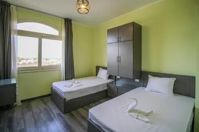a room with two beds and a window at All View Apartements, Sahl Hasheesh, El Andalous in Hurghada