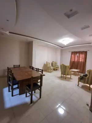 a large room with a wooden table and chairs at El Agamy Hotel Apartment in Luxor
