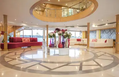 a lobby with a large room with a table with flowers on it at سحس جروب in Luxor