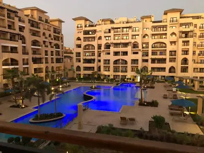 a large pool in front of a large building at Luxury Sea View Apartment Near Hurghada Airport in Hurghada