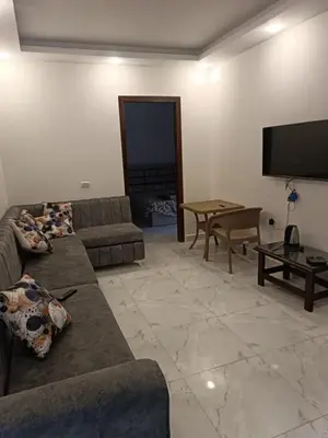 a living room with couches and a flat screen tv at ميراج باى in Hurghada