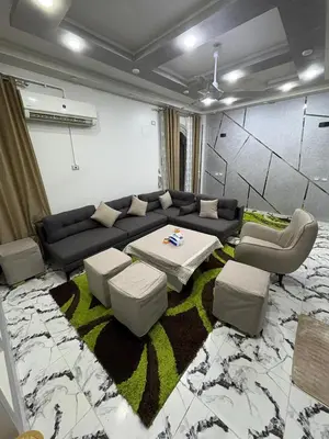 a living room with a couch and a table and chairs at fayrouz in Al Aqālitah