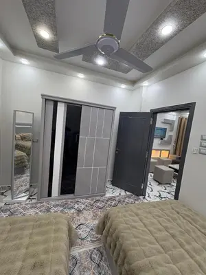 a bedroom with a bed and a large mirror at fayrouz in Al Aqālitah