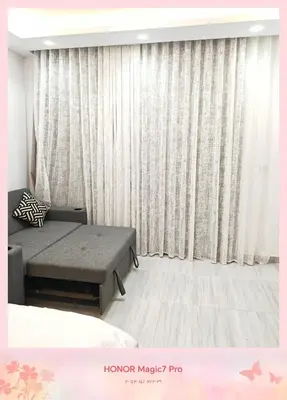 a bedroom with a bed and a window with curtains at Hambra avenue resort in Hurghada
