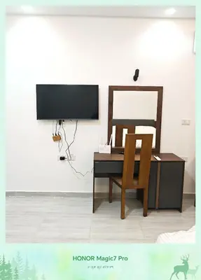 a desk with a mirror and a chair in a room at Hambra avenue resort in Hurghada