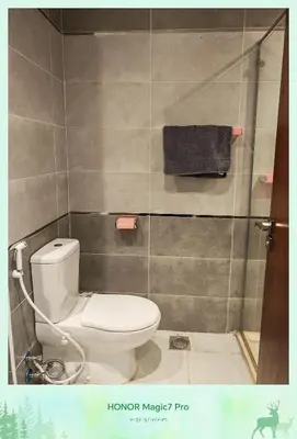 a bathroom with a toilet and a towel at Hambra avenue resort in Hurghada