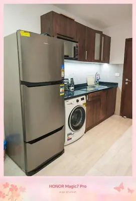 a kitchen with a refrigerator and a washing machine at Hambra avenue resort in Hurghada