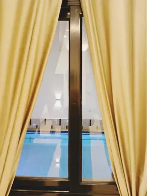 a window with a view of a swimming pool at NOOR SEEN House in Luxor