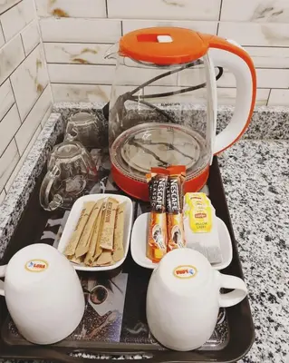 a kitchen counter with two tea pots and food at NOOR SEEN House in Luxor