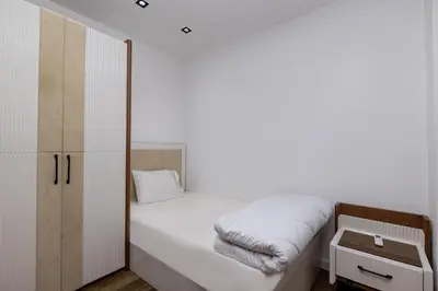 a small bedroom with a bed and a cabinet at Private Villa AL Mamsha Private Pool in Hurghada