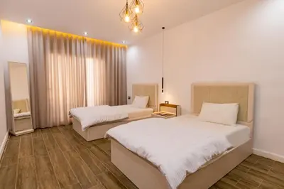 a bedroom with two beds and a chandelier at Private Villa AL Mamsha Private Pool in Hurghada
