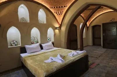 a bedroom with a bed with towels on it at Saray el omda wellness &retreat village in Al Karnak
