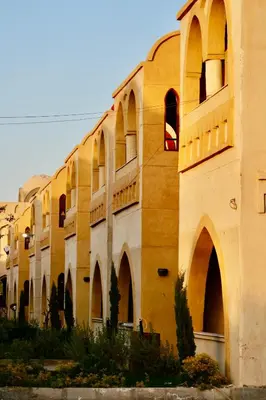 a large building with arched windows and a building with at Saray el omda wellness &retreat village in Al Karnak